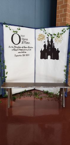 a bench with two banners on it sitting in front of a brick wall