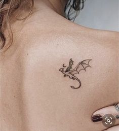 a woman with a dragon tattoo on her back