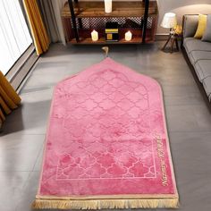 a living room with a pink rug on the floor