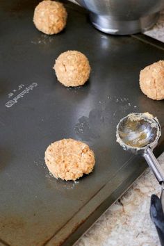 the doughnuts are being made on the cookie sheet and ready to go into the oven