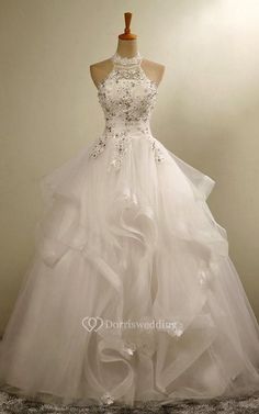 a white wedding dress on a mannequin with ruffles and beading