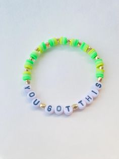 a green and white beaded bracelet with the words you got this written on it