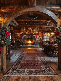 a large room decorated for christmas with decorations and lights on the ceiling, along with an ornate fireplace