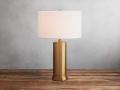 a gold lamp on a wooden table