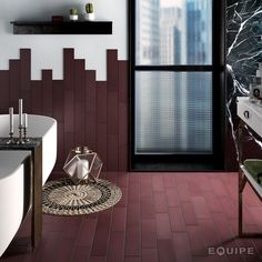 a bathroom with red tiles and white fixtures