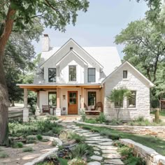 a white house with stone steps leading to the front door