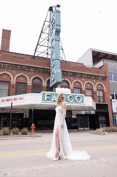 a woman standing in front of a theater