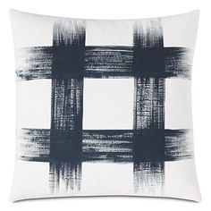 a black and white pillow with an abstract design on the front, in shades of blue