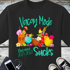 a black t - shirt with the words vacay mode on it next to a pair of sneakers