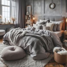 a bedroom with gray walls and white bedding, pillows and blankets on the floor