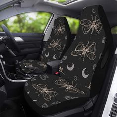 the seat covers in the car are decorated with butterflies and crescents on black fabric