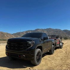 a black truck is parked in the desert