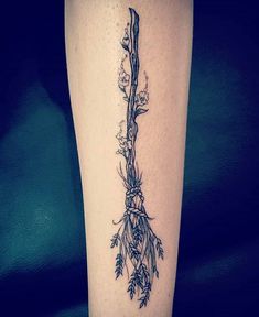 a tattoo on the leg of a woman with flowers and vines growing out of it