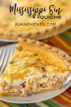 a close up of a slice of quiche on a plate with a fork in front of it