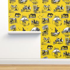 a yellow wallpaper with black and white farm animals on it in front of a wooden floor