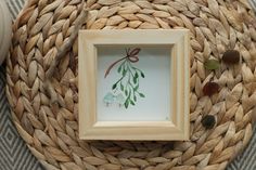 a photo frame sitting on top of a woven basket