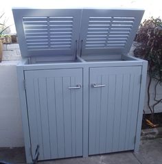 an outdoor storage cabinet with shutters on the doors