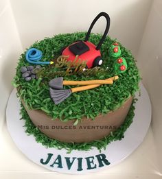 a cake with green grass and decorations on it