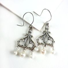 Our line of earrings make wonderful gifts or lovely accessories for your holiday festivities. Understated colors and refined sparkle will complete almost any formal outfit, while looking just as lovely with jeans and a t-shirt.Tiny genuine freshwater pearls dangle from fetching sterling silver filigree components.French wire ear hook. Measures 1.5 in/38 mm from top of hook to bottom of drop.Giving as a gift? Gift wrap available here:https://www.etsy.com/listing/157310249/gift-wrap-add-on-to-any- Luxury French Hook Earrings As Gift, Elegant Pearl Chandelier Earrings As A Gift, Nickel Free Elegant Chandelier Earrings For Anniversary, Nickel-free Elegant Chandelier Earrings For Anniversary, Pearl White Chandelier Earrings With Pearl Charm As Gift, Pearl White Chandelier Earrings Made Of Pearl For Gifts, Pearl White Chandelier Earrings With Pearl Charm, Elegant Nickel-free Dangle Pearl Earrings, Elegant Sterling Silver Chandelier Earrings Gift