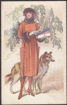 a woman is standing next to a dog in the snow with a book on her lap