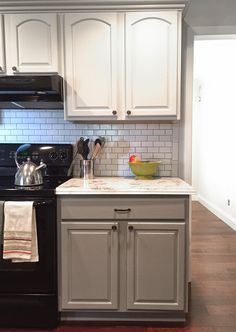 a black stove top oven sitting inside of a kitchen