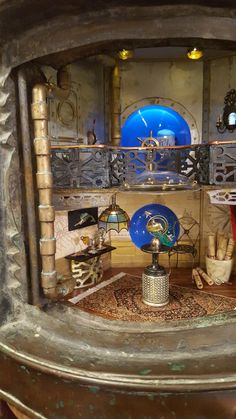 the inside of a clock tower with various items on it's display stand, including a blue glass plate