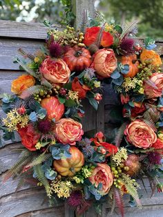 a wreath with orange and red flowers on it