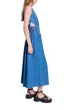 This season, the studio pays tribute to the celebratory spirit and timeless elegance of French fashion. An ode to glamour and sophistication, each piece embodies a party vibe and a sense of celebration, redefining chic with a touch of daring. Play the bold card with this long, slim-fit denim dress, accentuated with contrasting stitching. Its wide straps, with Clover links, define a V-neckline at the front and back. Its daring cutaways and smocked, elasticated waist flatter the figure for an asse Outfit With Platform Sandals, Fitted Denim Dress, Party Vibe, Blue Jean Dress, Contrasting Stitching, Denim Maxi Dress, Denim Maxi, Maxi Dress Blue, French Fashion