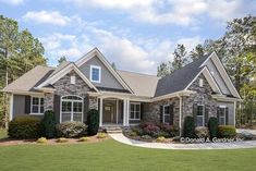 a large house with lots of windows and landscaping