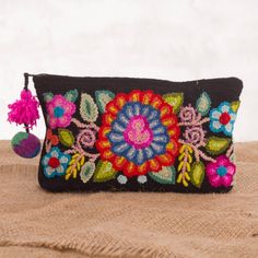 Designed by Milagros Campos this beautiful clutch is hand-crocheted with a colorful bouquet against a body of black. The designer works with local Andean artisans who hand-weave the clutch from 100% alpaca wool. Accented with a tassel and a pompom this handbag's zipper opens to a lined interior. Clutch Bouquet, Pretty Crafts, Colorful Bouquet, Gift Suggestions, Handwoven Fabric, Bouquet Design, Embroidery Fashion, Premium Gift, South American