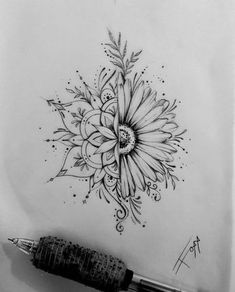 a drawing of a flower on paper next to a pen and ink dot marker, with the