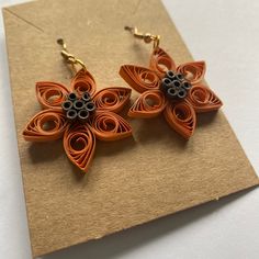 A pair of quilled flower earrings with orange petals and brown seeds. They are coated in matte varnish to help protect them from the elements. Paper Quilling Jewelry, Quilled Jewellery, Quilling Earrings, Quilling Jewelry, Flower Earring, Quilling Ideas, Upcycling Ideas, Quilling Art, Paper Quilling