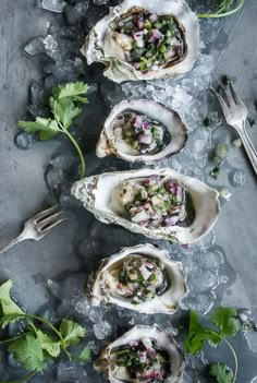 several oysters on ice with garnish and silverware