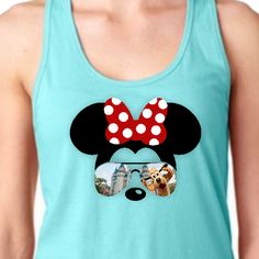 Minnie Mouse sunglasses tank top/Disney Cinderella’s castle with Pluto women’s summer tank top/Disney vacation Minnie bow silhouette tank featuring a Minnie Mouse silhouette with red polkadot bow and sunglasses with a silly Pluto at Cinderella’s castle reflection. The great athletic properties of this super soft cotton/poly tank top is sure to become your favorite tank. • 60% combed ringspun cotton, 40% polyester lightweight jersey• fabric laundered for reduced shrinkage • Racer back detail Disney Minnie Mouse Summer Tops, Cute Tops For Disney Fan Events In Summer, Disney Style Tops For Summer Fan Events, Mickey Mouse Tops For Disney Trips In Summer, Playful Mickey Mouse Tops For Summer, Playful Summer Tops With Mickey Mouse, Character Print Tops For Disney Fan Events In Summer, Character Print Tops For Summer Disney Fan Events, Casual Tops For Disney Trips In Summer