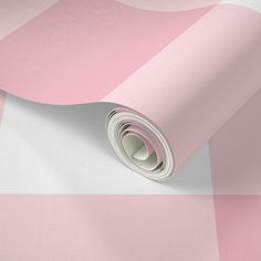 a pink and white checkered wallpaper with a rolled up roll on top of it