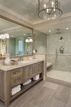 a large bathroom with two sinks and a walk in shower