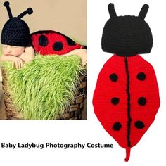 a baby laying in a basket with a crocheted ladybug hat on it