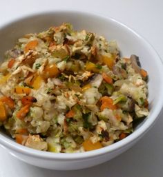 a white bowl filled with food on top of a table