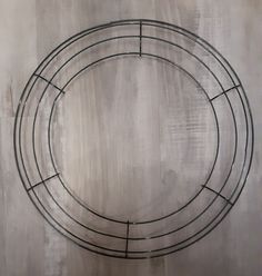 a metal circle on a wall with no one inside or outside in the photo, it appears to be part of an art installation