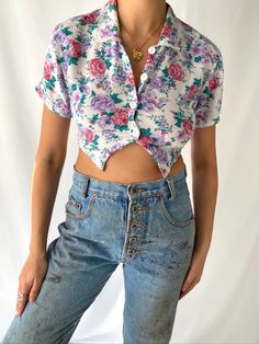 this is a super cute and comfortable vintage mini crop top from the 90s featuring a pretty floral print in shades of purple, pink and green on a white background. the short sleeved shirt features a collared neckline with white lacy trimming, a four white button front closure, and it is fitted around the bodice for a flattering silhouette. the blouse has a very cropped bottom hem (which is original to the design, it is not raw cut) that is pointed at the front and straight cut at the back. the fabric is an easy and lightweight rayon which makes it perfect for casual every day summer wear, and the garment is unlined.  such a lovely top that radiates granny cottagecore vibes! tagged as size medium but I would say this does not fit true to size, and would better fit womens size extra small or Mini Crop Top, Cottagecore Vibes, Fit Womens, Cropped Blouse, Lovely Tops, Cropped Tube Top, Blouse Shirt, Crop Blouse, 90s Vintage