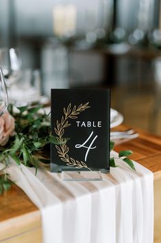 the table number is displayed with greenery