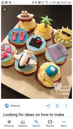 cupcakes decorated with different types of items on a plate and in the shape of beach scenes