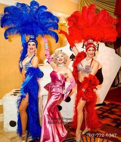 three women dressed in costumes posing for the camera