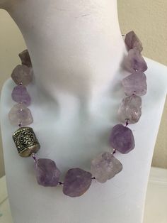 Amethyst Bold Necklace, hand-knotted in violet silk thread, 20 mm  natural rough, light amethyst stone, 6 mm rock crystal, 3 mm Swarovski crystal, antique African bead with sterling silver findings and toggle. This oneoff necklace is 19 inches in length, weight is 5.6 oz, handcrafted in North Palm Beach, Florida by designer artist Christine Smith. Gem Jewelry, Bold Necklace, Light Amethyst, Amethyst Jewelry, African Beads, Special Jewelry, How To Make Necklaces, Amethyst Necklace, Creative Jewelry