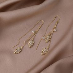 Make a statement when you wear this pair of enchanting goldtone threader earrings embellished with cat's eye and cubic zirconia. 0.47'' W x 3.4'' L Goldtone copper / cubic zirconia / cat's eye Sui Dhaga Earrings, Necklaces Indian, Small Earrings Gold, Hand Jewelry Rings, Necklaces Wedding, Nice Accessories, Ethereal Jewelry, Delicate Gold Jewelry, Bridal Necklace Designs