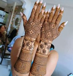 two women with henna tattoos on their hands