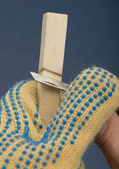 a person wearing a yellow sweater with blue dots and a knife stuck in the back