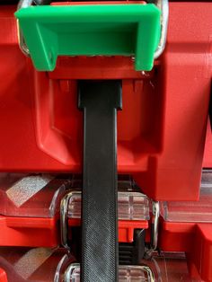 the inside of a red toolbox with tools in it's trays and wheels