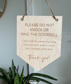 a wooden sign hanging from the side of a door that says, please do not knock or ring the doorbell