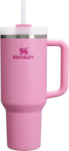 the stanley travel mug is pink and has a straw in it's cup holder